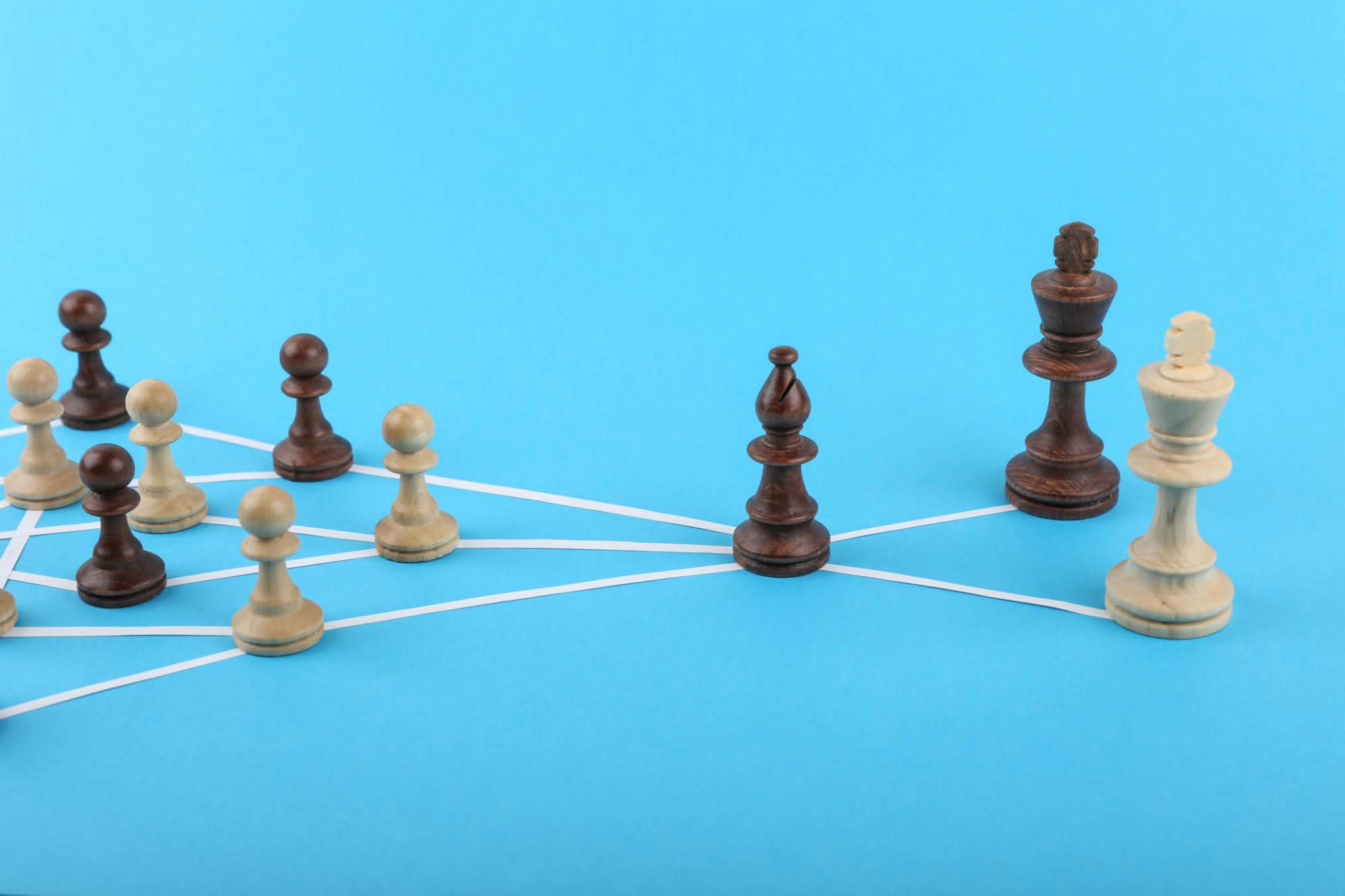 Chess pieces connected by lines representing strategic targeting and candidate matching for executive education programmes